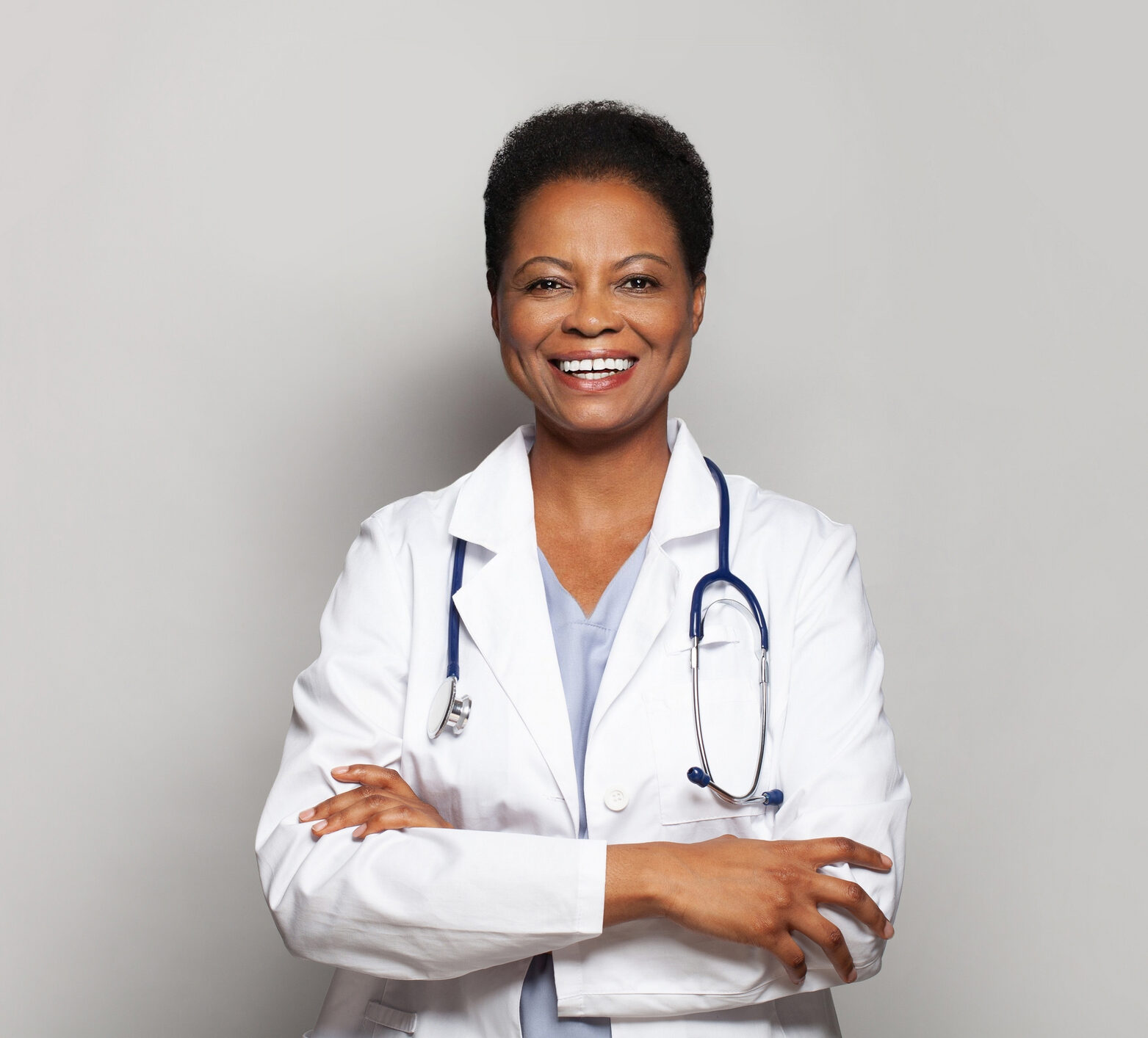 Doctor standing happily crossing her arms